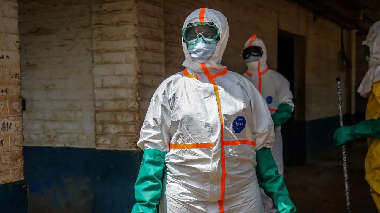  Health workers wearing protective equipment gather to disinfect the isolation area for Ebola patients. PIC/AFP